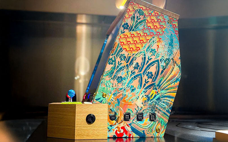 Side view of the Maison Roshi Sensei V3F Arcade Cabinet Wallasea highlighting intricate floral and abstract patterns on the panel with USB and power ports.