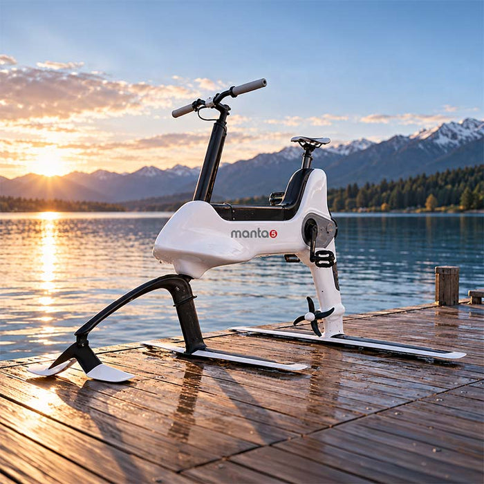 Manta5 Hydrofoiler SL3 Hydrofoil Bike displayed on a wooden lakeside dock at sunset