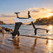 Manta5 Hydrofoiler SL3+ hydrofoil bike displayed on a waterfront dock at sunset