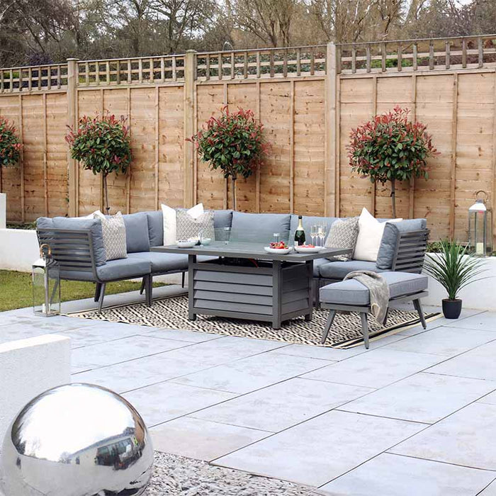 Grey Mayfair Corner Lounge Set with Fire Pit, enhancing the garden's contemporary aesthetic.