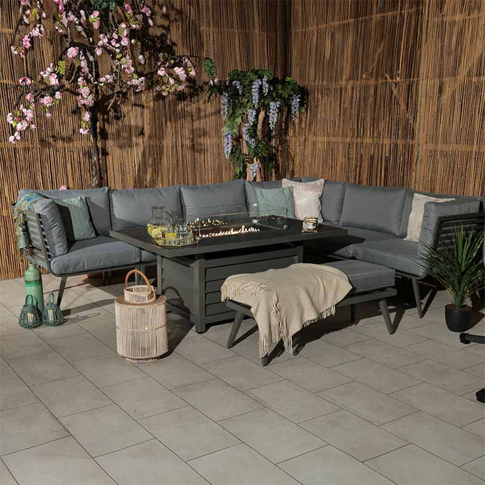 Mayfair Corner Lounge Set with Fire Pit, styled in a cosy evening outdoor setting.