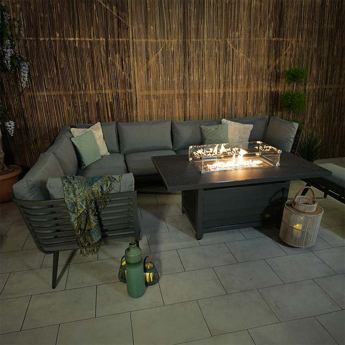 Stylish Mayfair Corner Lounge Set with a glowing fire pit, perfect for night-time gatherings.