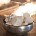 Bowl of marshmallows placed near the glowing fire pit, ready for toasting.