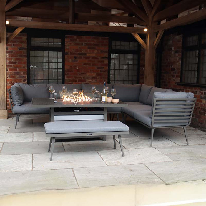 Grey corner seating arrangement ideal for outdoor gatherings, complete with a modern fire pit.