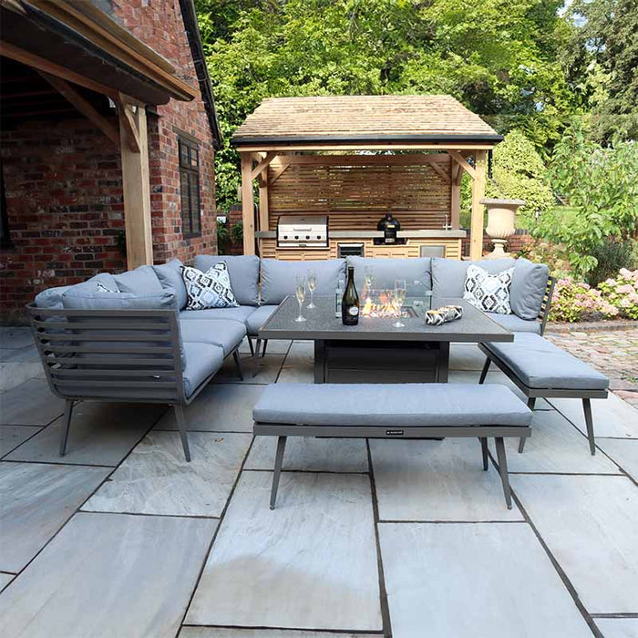 A stylish Mayfair Corner Lounge Set featuring a corner sofa, fire pit table, and two matching benches, perfect for outdoor relaxation.