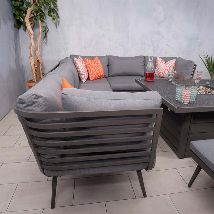 A rear view of the Mayfair Corner Lounge Set, showcasing the sleek, slatted design of the backrest and the plush grey cushions, creating a modern and comfortable outdoor seating area.