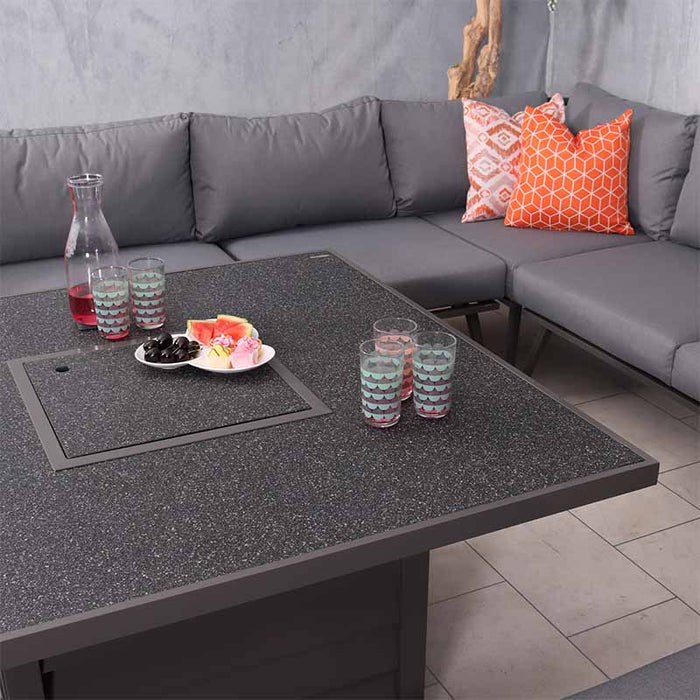 The Mayfair Fire Pit Table with the cover on, displaying a stylish spread of drinks and snacks, perfect for both dining and lounging in your outdoor space.