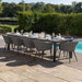 Ambition 10 seater extending dining set in flanelle, offering a sleek and modern outdoor dining space by the pool.