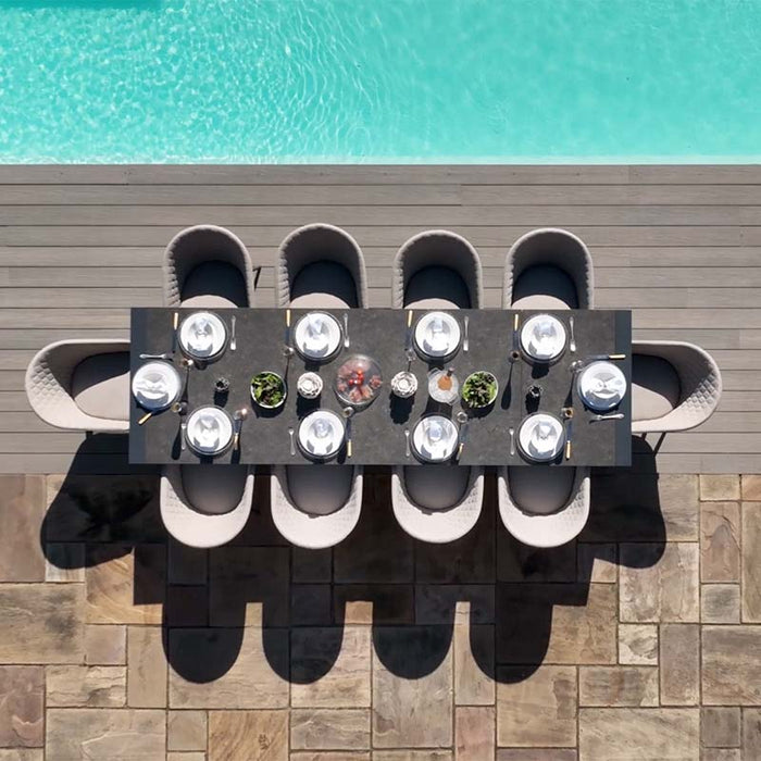 Top view of the Ambition 10 seater extending dining set in oatmeal, arranged by the pool with tableware set for outdoor dining.