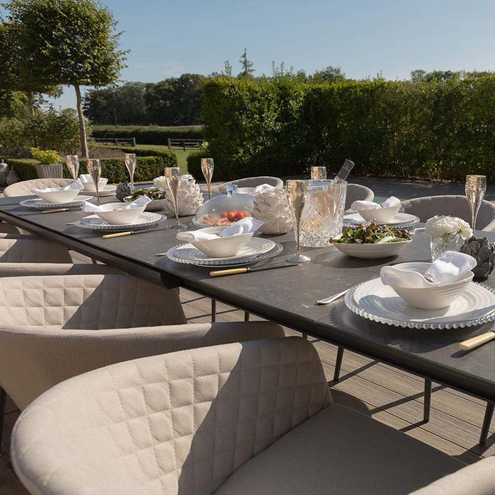 Ambition 10 seater extending dining set in oatmeal, close-up view of the table setting with elegant tableware and champagne glasses.