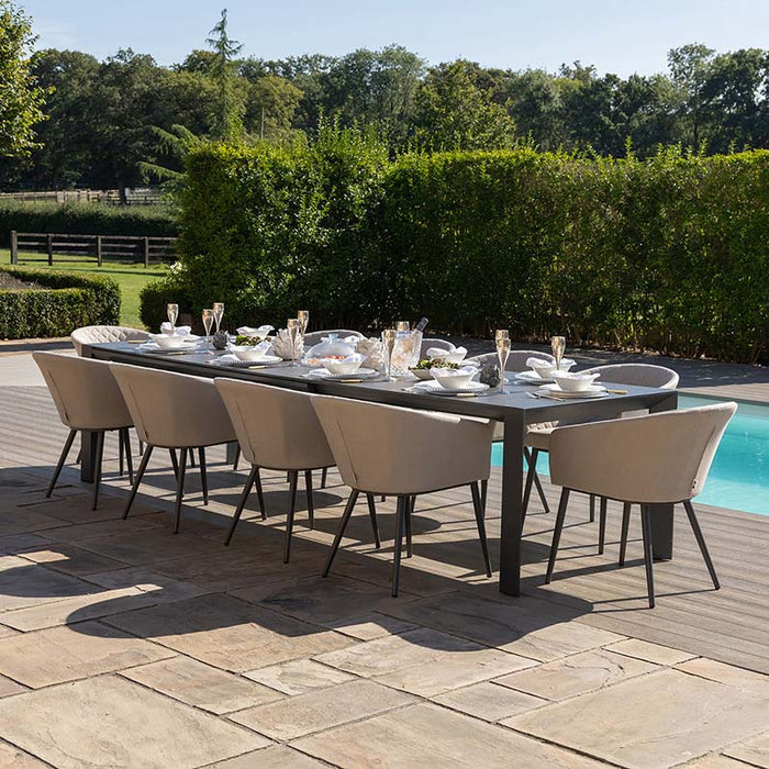 Ambition 10 seater extending dining set in oatmeal, arranged outdoors by the poolside, featuring comfortable chairs and a sleek, modern table for luxury dining.