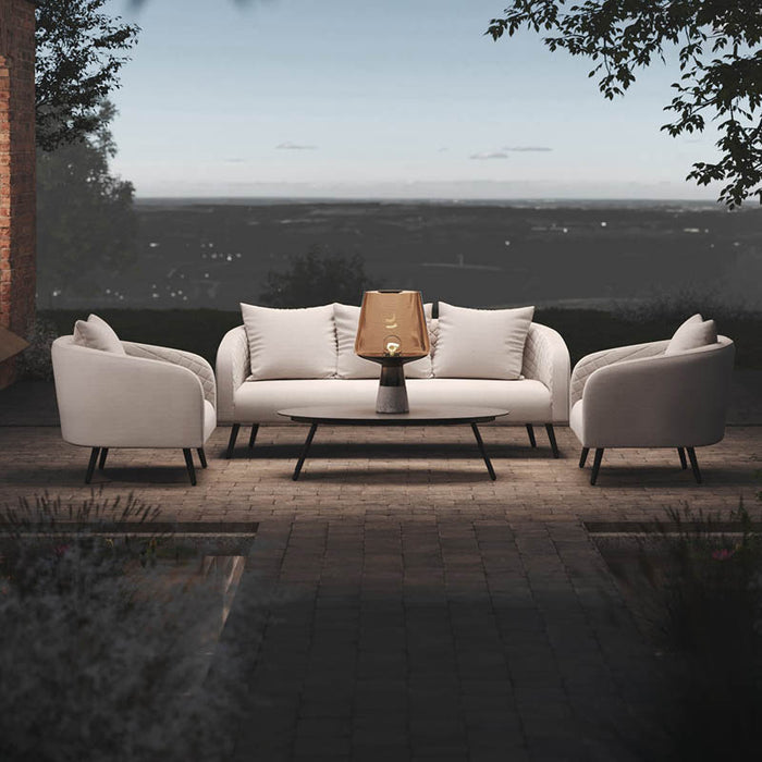 Evening view of the Ambition 3 Seater Sofa Set with oatmeal fabric, set in an outdoor patio space.