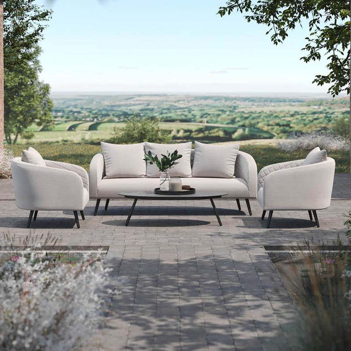 Full frontal view of the Ambition 3 Seater Sofa Set in oatmeal fabric, arranged on a patio with lush garden surroundings.