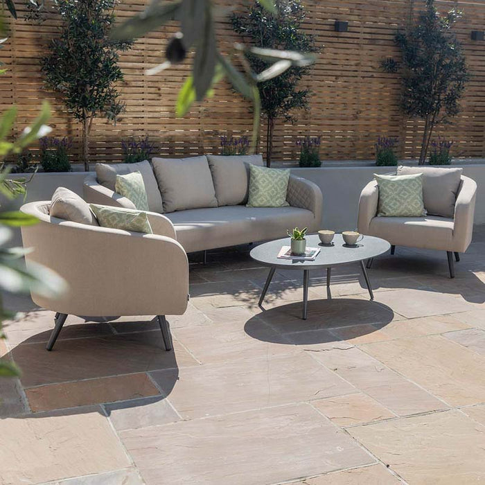 Front view of the Ambition 3 Seater Sofa set in oatmeal, placed on a patio, demonstrating its elegant outdoor style.