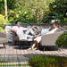 Ambition 3 Seater Sofa Set in Taupe with modern armchairs, shown in a relaxed patio setting.