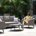 Elegant Ambition 3 Seater Sofa in taupe with modern grey cushions and armchair, outdoor setting.