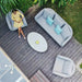 Top view of the Ambition 3 Seater Sofa Set in Lead Chine, featuring an oval coffee table, sofa, and armchairs, arranged on a wooden deck for a modern outdoor look.