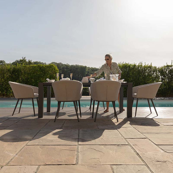 Ambition 6 seater extending dining set in oatmeal, designed for comfortable outdoor dining by the pool.