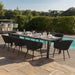 Ambition 8 seater extending dining set in charcoal, offering a sleek design for outdoor dining near the pool.