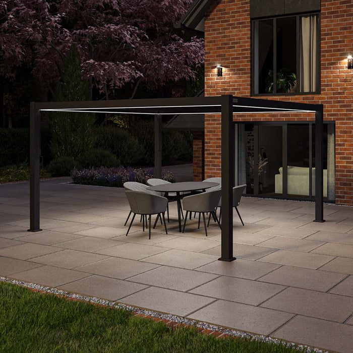 Illuminated night view of the Como 4m x 4m Aluminium Garden Pergola in Anthracite Grey, featuring integrated LED lights for a modern and atmospheric evening setting.