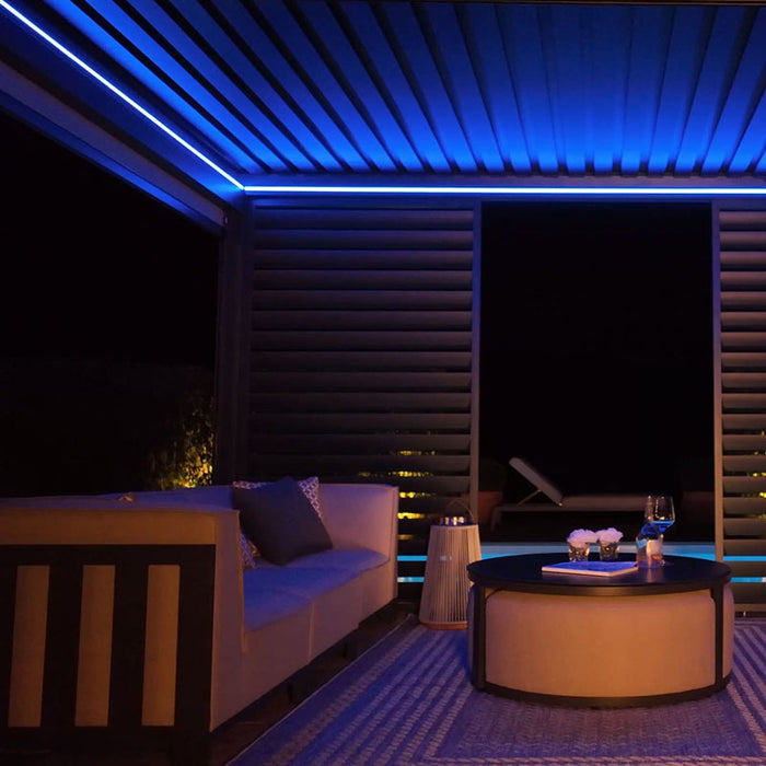 Eden Aluminium Garden Pergola glowing with striking blue LED lights, creating a peaceful and contemporary outdoor environment.