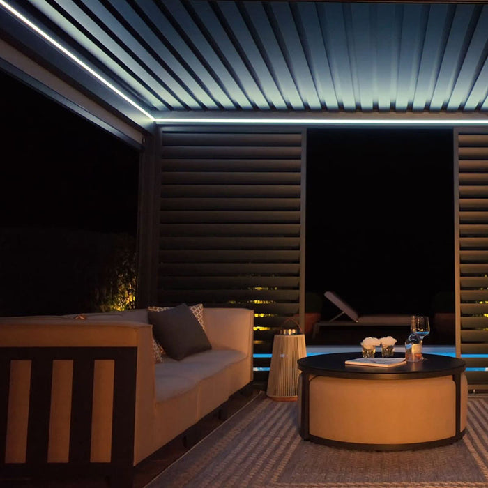 Eden Aluminium Garden Pergola illuminated with soft white LED lights, providing a clean and elegant glow for outdoor evenings.