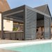 A modern, sleek aluminium pergola with motorised louvres, offering a stylish outdoor space for relaxation near a pool.