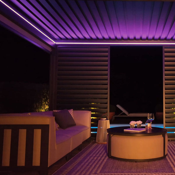 The pergola’s modern design is enhanced by purple LED lighting, adding a sophisticated, atmospheric touch to outdoor settings.