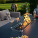 The fire pit in action on the Pulse 3 Seater Dining Set, providing a glowing centrepiece for relaxed outdoor dining.