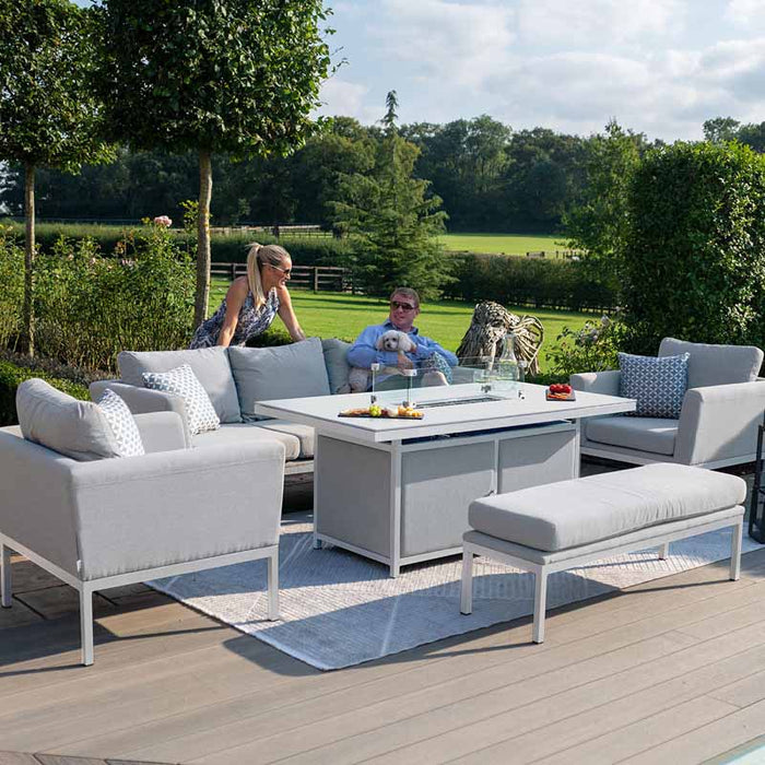 Pulse 3 Seater Sofa Dining Set with Fire Pit in outdoor setting with couple enjoying drinks, featuring lead chine cushions and stylish design.