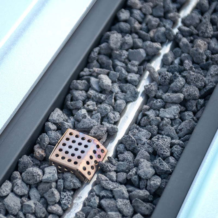 Close-up of lava rocks inside the fire pit of the Pulse 3 Seater Sofa Dining Set, highlighting premium fire feature details.