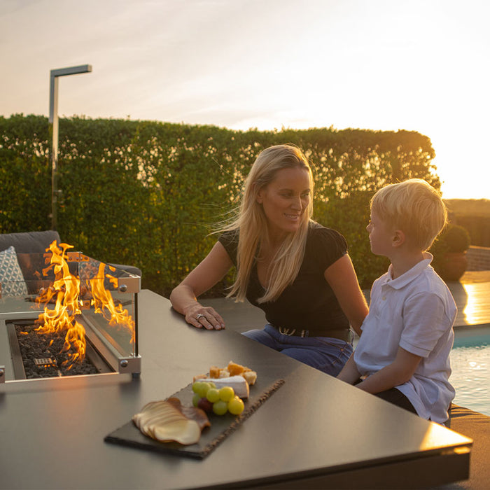 Mother and son relaxing near the fire pit in the Pulse 3 Seater Sofa Dining Set.