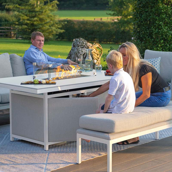 Pulse 3 Seater Sofa Dining Set with Fire Pit, family enjoying a relaxing outdoor evening by the fire, lead chine cushions adding comfort.