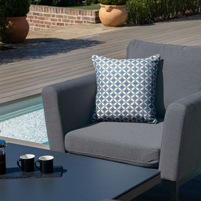 A zoomed-in shot of the patterned throw pillow and sleek cushion on the Maze Pulse Dining Set in flanelle grey.