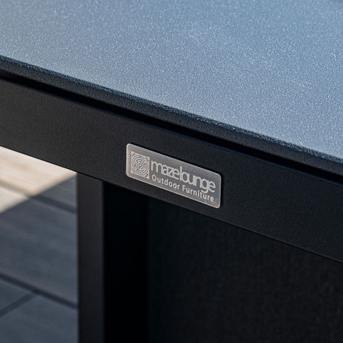 Close-up of the branded corner of the rising table on the Maze Pulse 3 Seater Sofa Dining Set in Charcoal, highlighting the premium quality finish.