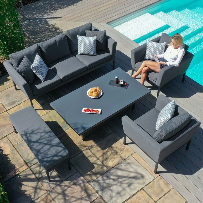 Overhead view of the Maze Pulse 3 Seater Sofa Dining Set with Rising Table in flanelle, arranged next to a pool. The sleek design includes a sofa, armchairs, bench, and adjustable table, offering a perfect spot for outdoor relaxation.