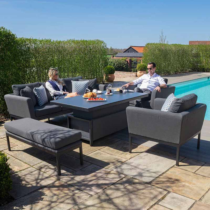 A couple enjoying the Maze Pulse 3 Seater Sofa Set in flanelle grey, set next to a luxurious pool.