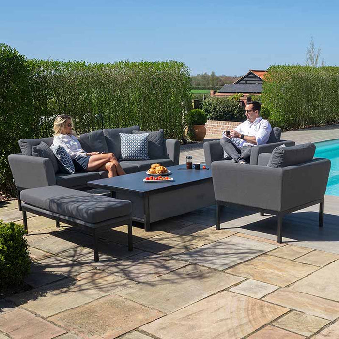 Two people relaxing on the Pulse 3 Seater Sofa Dining Set with Rising Table in a poolside setting, featuring flanelle cushions and a modern outdoor aesthetic.