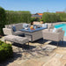 A full lifestyle view of the maze Pulse 3 Seater Sofa Dining Set in Oatmeal, arranged poolside, with armchairs, a bench, and a rising table, creating an ideal space for outdoor lounging and dining.