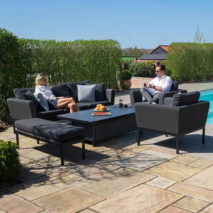 A lifestyle setting featuring the Pulse 3 Seater Sofa Dining Set in charcoal, arranged poolside for a modern and comfortable outdoor experience.