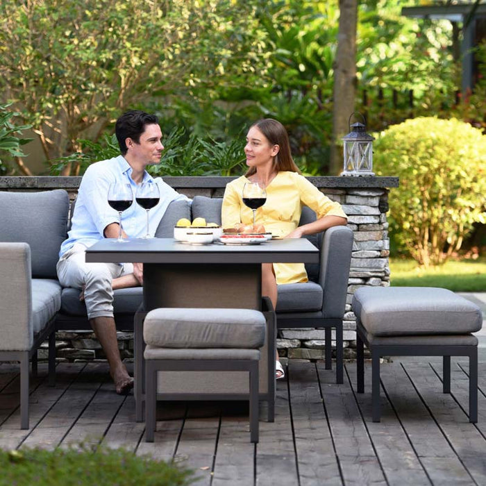 Intimate moment captured as a couple unwinds on the Pulse Left-Handed Dining Set, surrounded by lush greenery and enjoying the peaceful outdoor atmosphere.