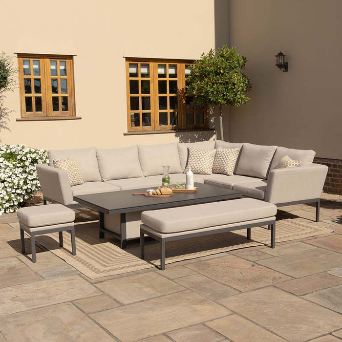 View of the Pulse left-handed dining set showing the rising table set for refreshments, surrounded by a sectional sofa and ottomans on a wooden deck, perfect for gatherings.