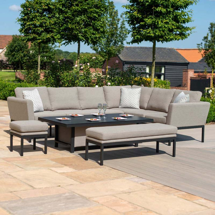 The Pulse dining set with taupe cushions and a rising table, set in a scenic garden, showcasing its versatile design and suitability for outdoor dining and relaxation.