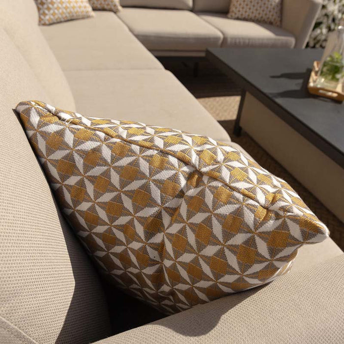 A close-up of a stylish patterned cushion on the Pulse left-handed corner dining set, adding a decorative touch to the soft oatmeal seating, enhancing the set's modern appeal for outdoor lounging.