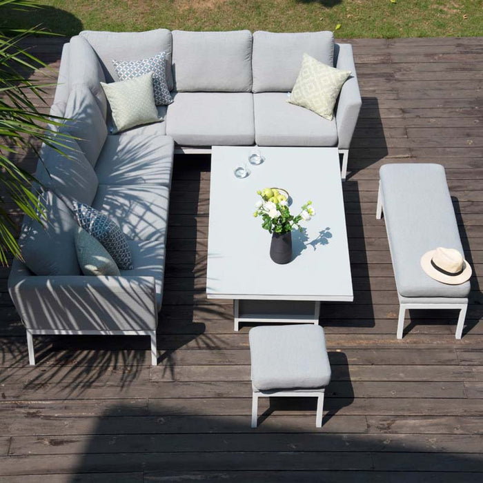 The Pulse corner dining set in a garden setting showcases plush cushions and a rising table, ideal for versatile outdoor lounging or dining.