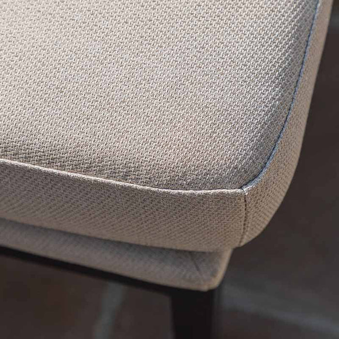 Close-up of the cushion fabric on the Pulse Rectangular Corner Dining Set with Rising Table in oatmeal. The durable, textured linen fabric offers both comfort and style, enhancing the seating experience.