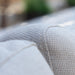 A close-up of the smooth fabric texture on the armrest of the Pulse Rectangular Corner Dining Set in oatmeal.