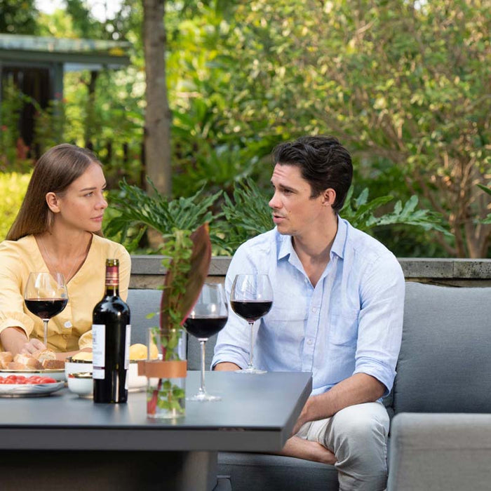 Captures the relaxed and intimate vibe of the couple enjoying a meal, emphasizing the spacious seating area.