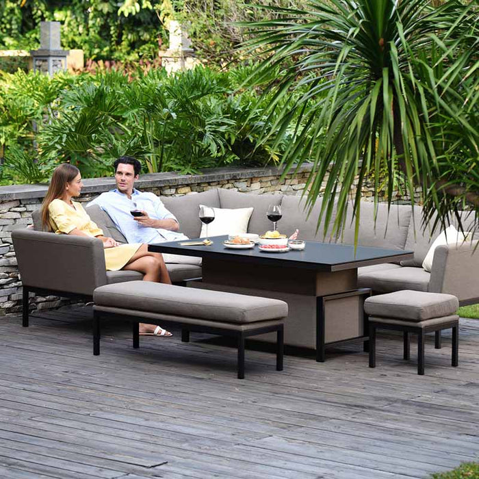 Couple relaxing on the Maze Pulse Rectangular Corner Dining Set with Rising Table in taupe.