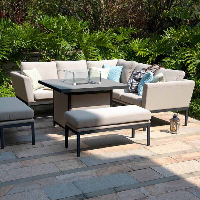 A sleek and modern Pulse Corner Dining Set in oatmeal, with a fire pit table at the centre, ideal for outdoor dining and lounging.